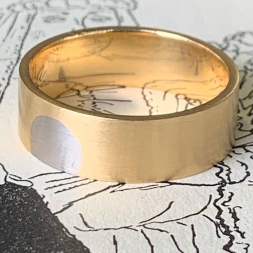 Orbit wedding ring by Gary Barnes. Handcrafted in 18ct yellow gold, featuring a smooth, modern design with a distinctive, continuous band for timeless elegance.