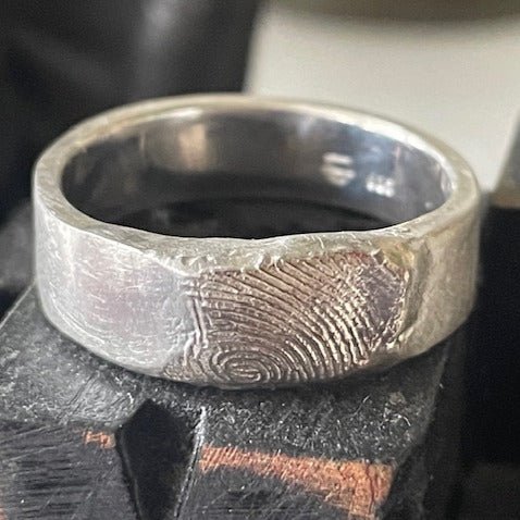 7mm sterling silver fingerprint ring, uniquely engraved with a personal fingerprint design, making each piece truly one-of-a-kind.