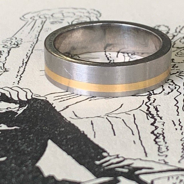Inlay wedding ring by David Parker. Handcrafted in titanium with a luxurious gold inlay, combining modern durability with classic elegance.