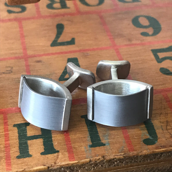 Tenion cufflinks by David Parker. Handcrafted in sterling silver and titanium, featuring a sleek, contemporary design with contrasting materials for a bold look.