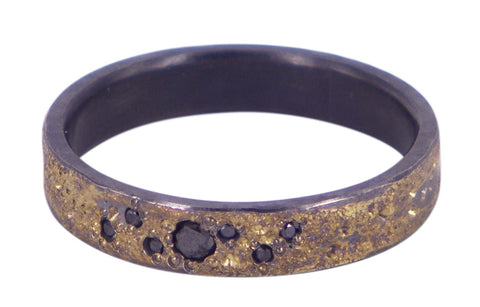 Handmade men's wedding ring by Jeanette Dyke in oxidised silver and 18ct yellow gold, featuring 6 black diamonds. Unique Melbourne-made Australian craftsmanship.