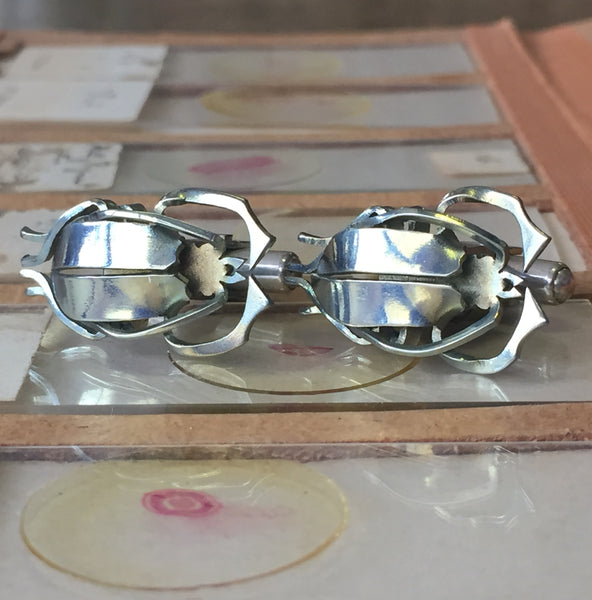 Longhorn Beetle Mint cufflinks by Justin Siow. Handcrafted in titanium, hand-cut, folded, and heat-treated, featuring intricate beetle detailing for a bold look.