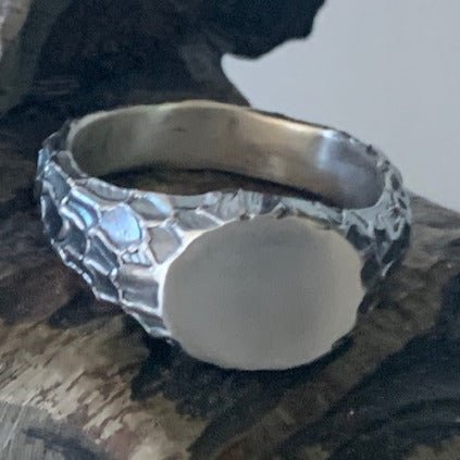 Centre signet ring by Unnon. Handcrafted in sterling silver, featuring a sleek, minimalist design with a bold, smooth center for a modern, timeless look.